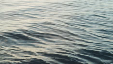 Close-up-shot-of-ocean-water-in-the-morning-light-out-at-sea