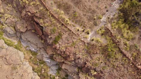 Dry-river-valley-in-desert-landscape-of-Tenerife,-aerial-top-down-view