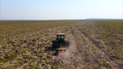 Tractor-diligently-preparing-the-soil-for-planting,-showcasing-the-essential-agricultural-process-of-land-preparation