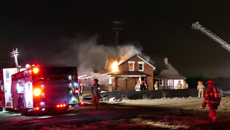 Firefighters-are-working-hard-to-extinguish-a-nighttime-house-fire