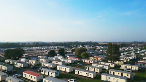 Immerse-yourself-in-Skegness's-holiday-parks,-capturing-caravans,-holiday-homes,-and-the-picturesque-countryside-in-this-aerial-video-on-a-summer-evening