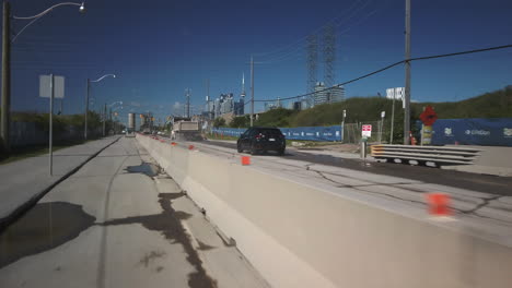 Wide-travelling-point-of-view-of-city-traffic-on-dusty-Villiers-Street