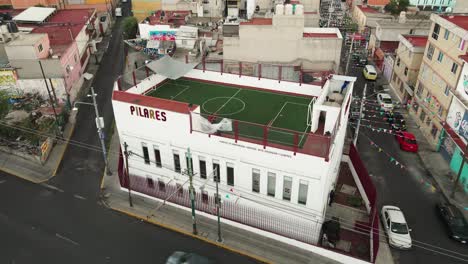 Rooftop-football-pitch-in-north-mexico-city,-aerial-drone-shot,-fixed-shot