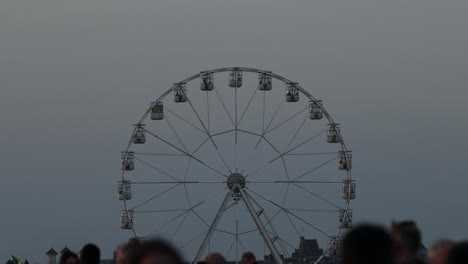 Static-shot-of-a-large-Ferris-wheel-going-around-at-the-Festival-of-Flight,-Ayr