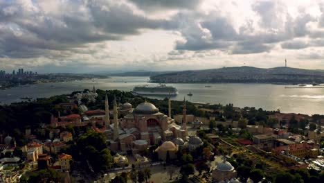 Sunset's-grandeur-meets-architectural-splendor:-A-drone's-eye-view-captures-Istanbul's-Blue-Mosque,-harmonizing-with-the-colossal-canvas-of-clouds
