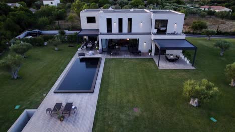 Aerial-revealing-shot-from-inside-a-luxury-countryside-mansion-with-a-pool-in-Uzes