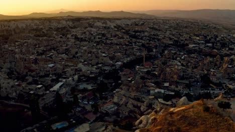 Goreme,-Cappadocia,-shimmers-in-the-moonlight-from-an-aerial-perspective