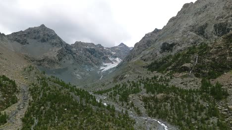 Epic-aerial-shot-of-Alpe-Ventina-mountain-landscape,-sliding-sidewyas,-day