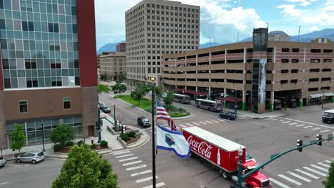 Coca-Cola-truck-driving-through-downtown-Colorado-Springs,-CO