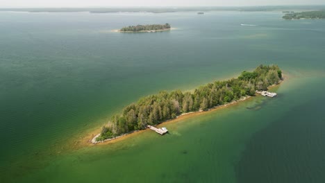Aerial-orbit-of-colorful-small-island-on-lake-Huron,-Michigan
