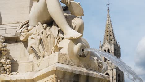 Slider-shot-near-fountain-reveals-cathedral-of-Nimes-,Gothic-catholic-church-of-seventeenth-century-dedicated-to-Castor-of-Apt-and-Virgin-Mary