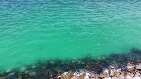 Panoramic-aerial-view-of-channel-markets-at-Shell-Island-with-Green-crystal-clear-waters,-Blue-skies,-and-white-sands