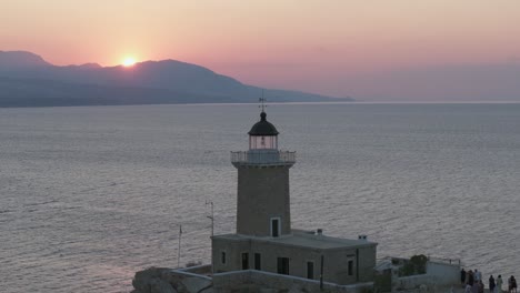 Lighthouse-in-Melagavi,-Corinth,-Greece-at-sunset