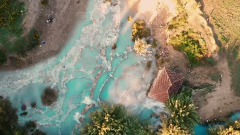 Cascate-del-Mulino,-Soothing-Natural-Hot-Springs-Bath,-Saturnia,-Tuscany,-Italy,-Europe,-Drone-view-traveling-up,-bird-view,-zenithal