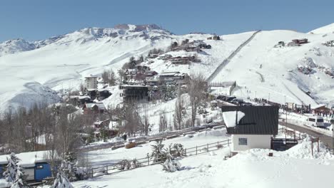 Aerial-Drone-Fly-Above-Farellones-Ski-Resort-Snowed-Andean-Mountain-Cordillera-Travel-Destination-in-Chile,-Establishing-Shot