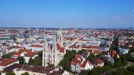 Beautiful-aerial-top-view-flight-Munich-city-Paul-Church-at-theresienwiesen,-Germany-Bavarian-Town-at-sunny-clear-sky-day-2023