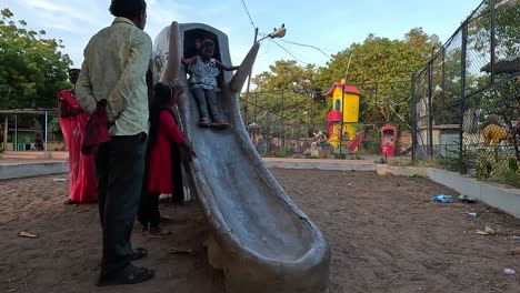 Little-kids-are-enjoying-the-sliding-ride-with-their-parents