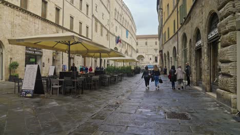 Walking-along-the-main-street-called-Corso-Pietro-Vannucci-in-Perugia,-Province-of-Perugia,-Italy
