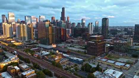 Aerial-view-approaching-the-sunlit-Fulton-market,-golden-hour-in-Chicago,-USA