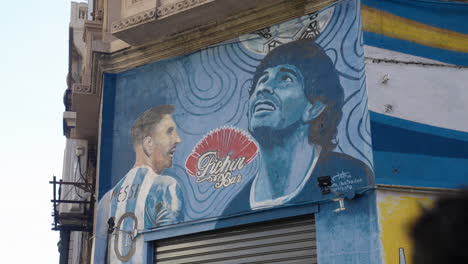 Graffiti-of-Messi-and-Maradona-together-on-the-facade-of-a-classic-restaurant-in-the-center-of-Buenos-Aires-on-Avenida-de-Mayo,-Argentina