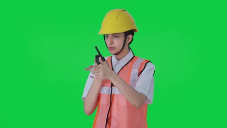Indian-female-architect-giving-instructions-on-walkie-talkie-Green-screen