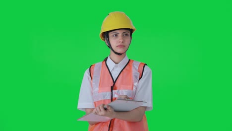 Indian-female-architect-taking-notes-in-building-Green-screen
