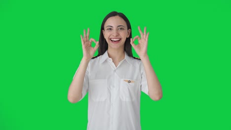Happy-Indian-woman-pilot-showing-okay-sign-Green-screen