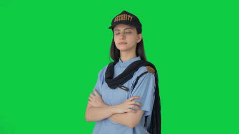 Portrait-of-Indian-female-security-guard-standing-crossed-hands-Green-screen