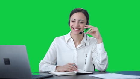 Happy-Indian-call-center-girl-talking-to-customer-and-taking-notes-Green-screen