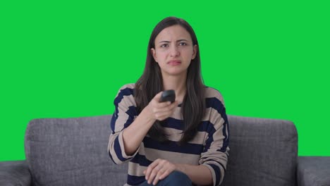 Indian-girl-trying-to-fix-TV-remote-Green-screen