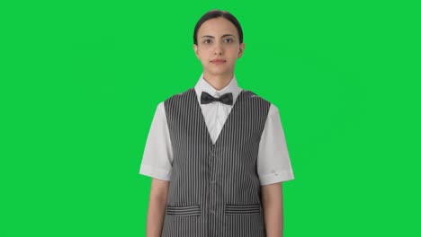 Indian-woman-waiter-looking-at-someone-Green-screen