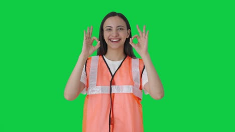 Happy-Indian-airport-ground-staff-girl-showing-okay-sign-Green-screen