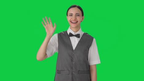 Happy-Indian-woman-waiter-saying-Hi-and-waving-Green-screen