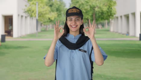 Happy-Indian-female-security-guard-showing-okay-sign