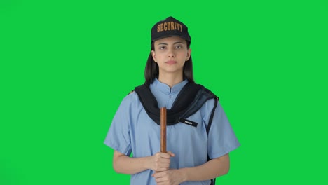 Indian-female-security-guard-listening-to-someone-Green-screen