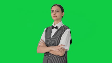 Portrait-of-Indian-woman-waiter-standing-crossed-hands-Green-screen
