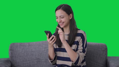 Happy-Indian-girl-using-phone-Green-screen