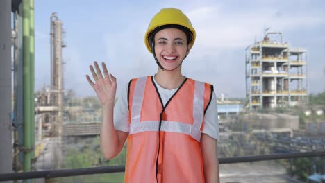 Happy-Indian-female-construction-worker-waving-Hi