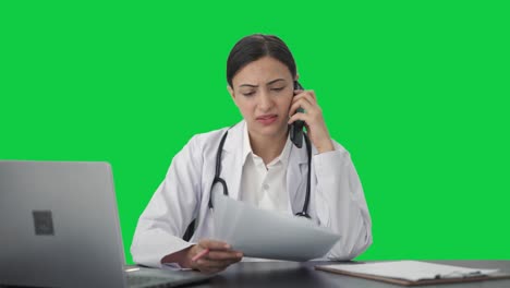 Sad-Indian-female-doctor-explaining-report-to-patient-on-call-Green-screen
