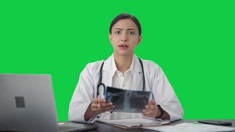 Angry-Indian-female-doctor-explaining-X-ray-report-to-patient-Green-screen
