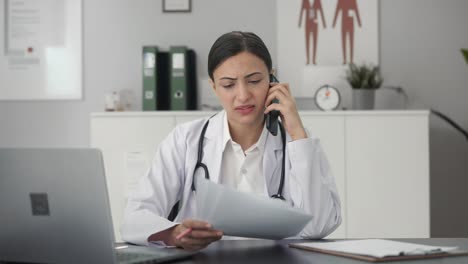 Sad-Indian-female-doctor-explaining-medical-report-to-patient-on-call