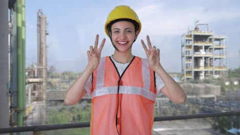 Happy-Indian-female-construction-worker-showing-victory-sign