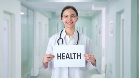 Happy-Indian-female-doctor-holding-HEALTH-banner