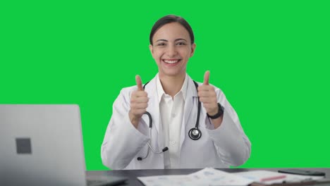 Happy-Indian-female-doctor-showing-thumbs-up-Green-screen