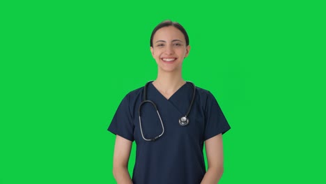 Happy-Indian-female-doctor-putting-stethoscope-on-Green-screen