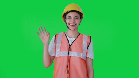Happy-Indian-female-construction-worker-waving-Hi-Green-screen