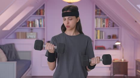 Indian-woman-lifting-heavy-dumbbells-weight