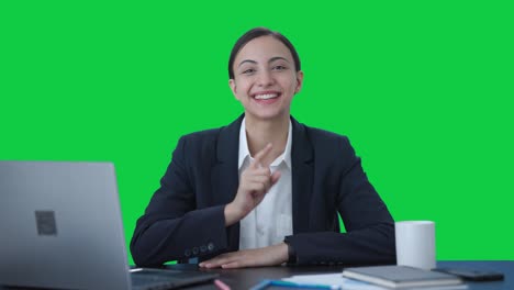 Happy-Indian-female-manager-talking-to-someone-Green-screen