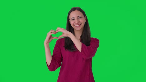 Happy-Indian-girl-making-heart-sign-Green-screen