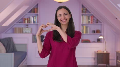 Happy-Indian-girl-making-heart-sign